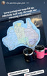 Map of Australia on a surface with two mugs, indicating a travel journey.