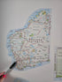 Map of Western Australia with a hand holding a pen pointing at a location.