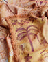 Close-up of rust orange Australia map picnic rug with palm tree print and fringed edge Adventure Awaits