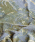 Green woven backing of Australia map picnic rug with travel icons and soft texture Adventure Awaits