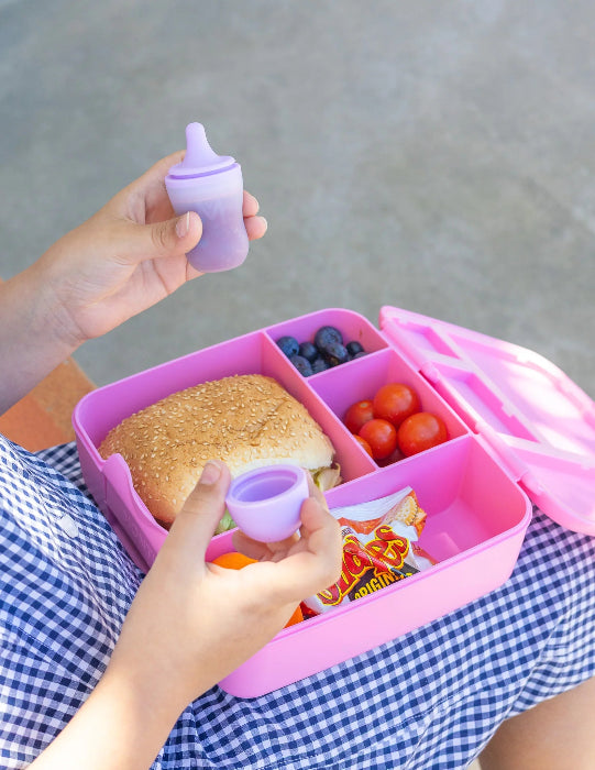 Silicone sauce bottle with lunch box containing food