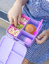 Silicone sauce bottle with lunch box containing food