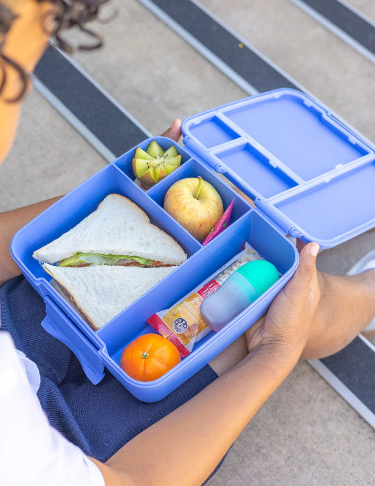 Silicone sauce bottle with lunch box containing food