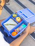 Silicone sauce bottle with lunch box containing food