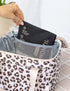 Hand removing a reusable ice pack from the mesh pocket inside a leopard print insulated lunch bag — Adventure Awaits