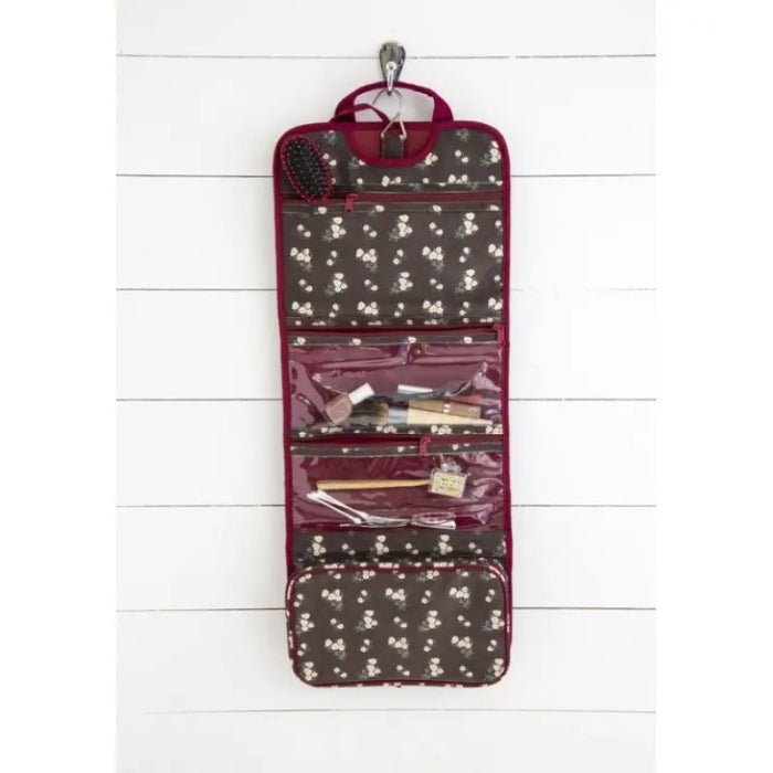Hanging floral travel toiletry organiser with clear zip pockets and beauty accessories inside