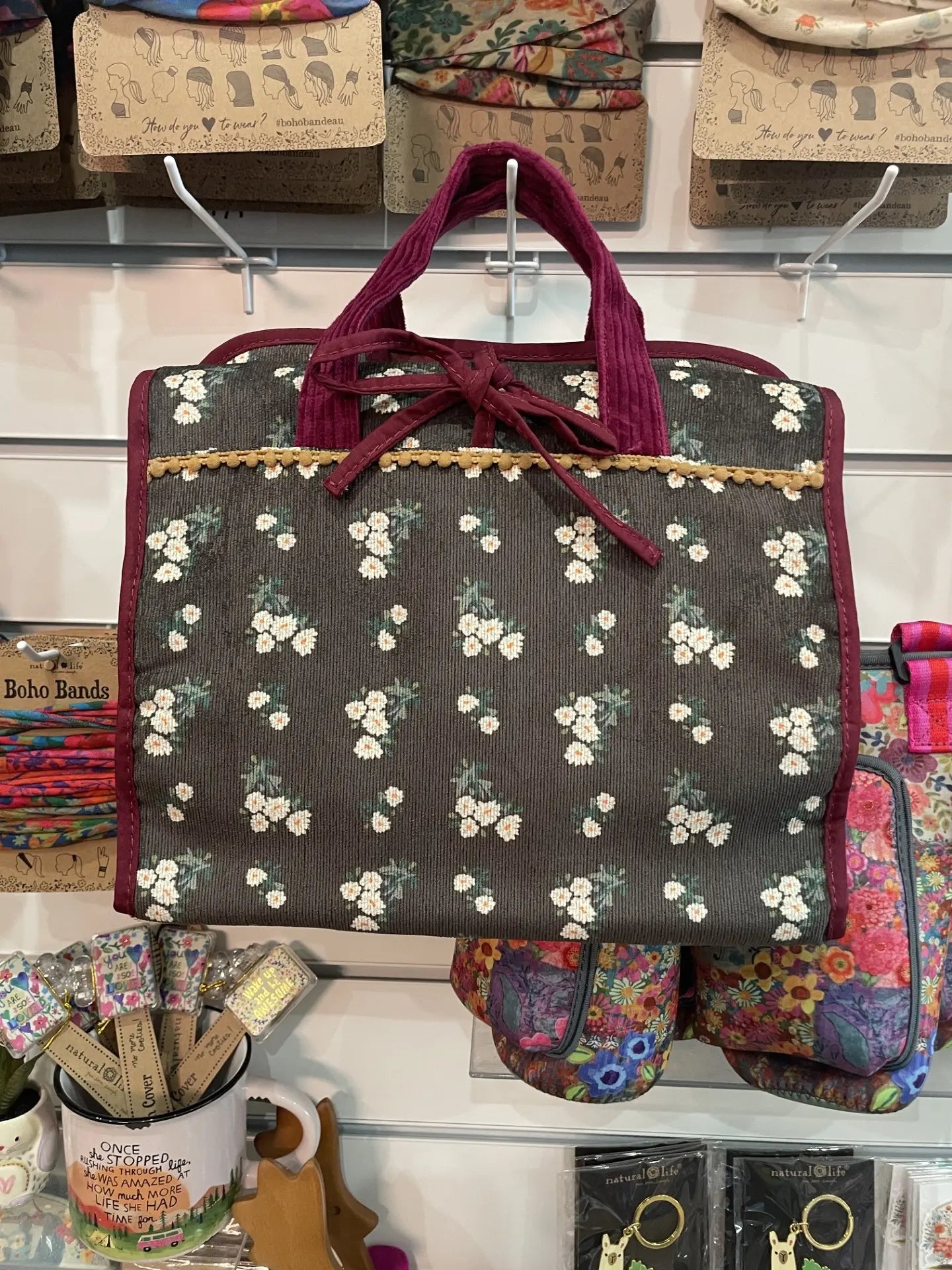 Floral roll up travel organiser bag with burgundy handles, tie closure and vintage inspired print