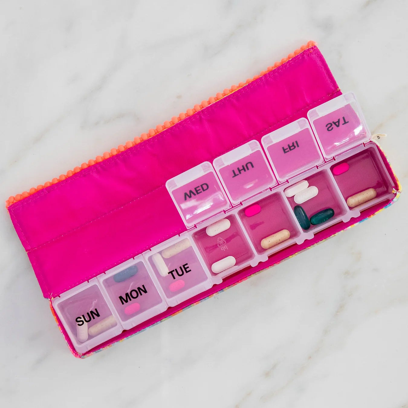 Nature life weekly pill organiser showing the inside with compartments open and pills inside