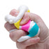 Hand squeezes a NeeDoh Piece O’ Cake sensory toy, showing its colourful soft layered filling — Adventure Awaits