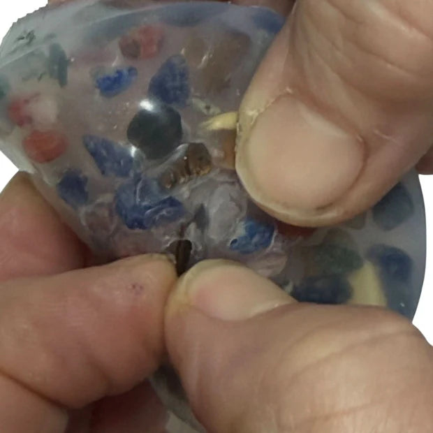 close up of kaiko pick 'em disc with stones being extracted with fingers