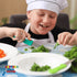 child cutting herbs using a green safety food kutter - large