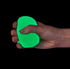 Hand squeezing green glow in the dark gumdrop squishy toy against black background — Adventure Awaits