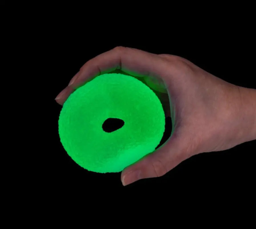 Smooshos glow in the dark super squeeze doughnut glowing green in hand — Adventure Awaits