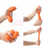 Hands squeeze, twist and stretch an orange sausage-shaped squishy sensory toy — Adventure Awaits