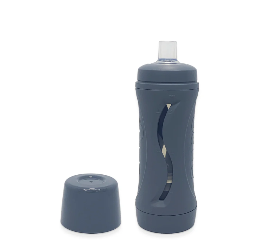 charcoal subo the food bottle shown with lid removed and sitting beside the bottle on a white background
