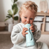 toddler using subo food bottle