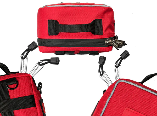 Red Survival Family First Aid kit close-up showing handles, zips and carry attachments — Adventure Awaits