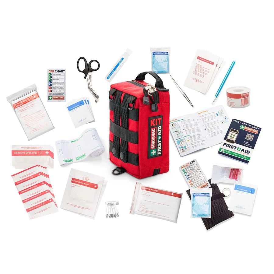 Red Survival Handy First Aid kit with compact carry case and emergency supplies laid out — Adventure Awaits