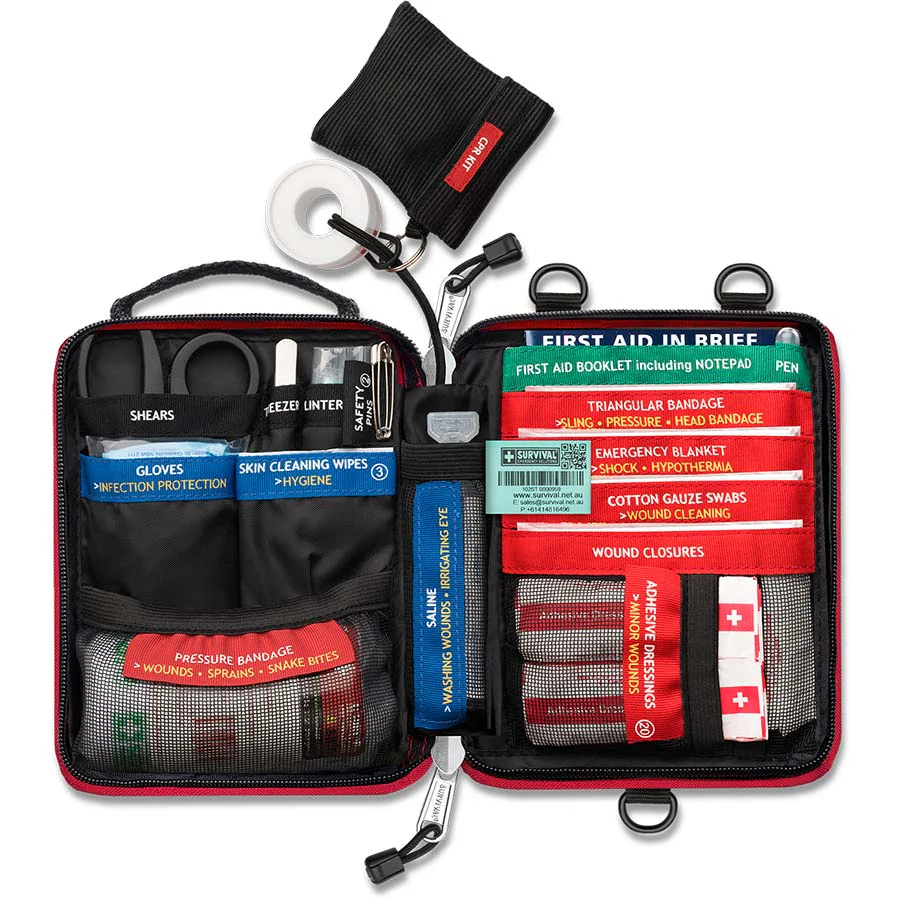 Red Survival Handy First Aid kit opened with colour coded emergency supplies — Adventure Awaits