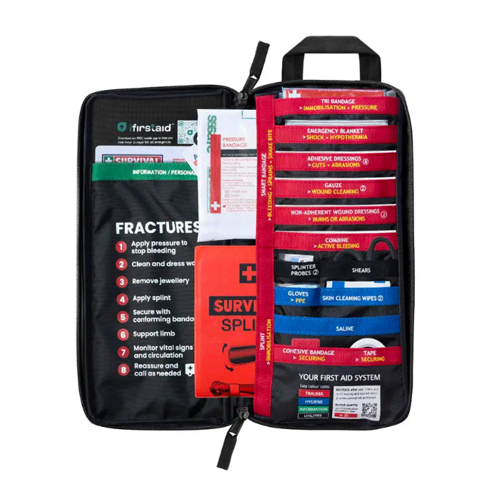 Red Survival First Aid kit opened with colour-coded supplies and fracture guide — Adventure Awaits