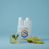Lime and mint drink with fresh lime halves beside a white Standard Squeeze Bottle — Adventure Awaits