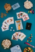 The Golden Sausage card game set out with cards, popcorn, pretzels and lollies — Adventure Awaits