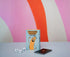 The Golden Sausage card game box with card deck and three number dice on colourful striped background — Adventure Awaits