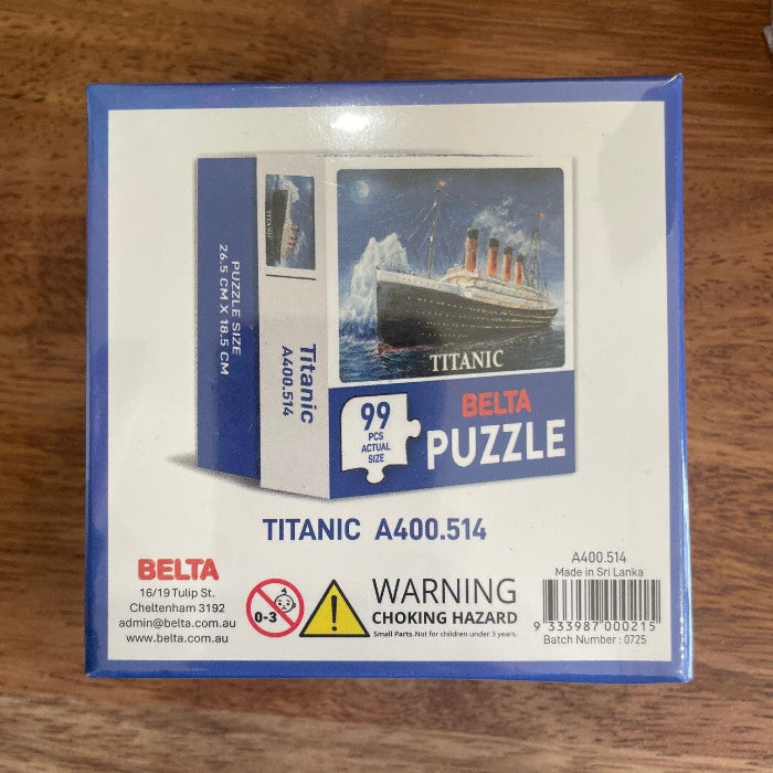 Back of Titanic 99 piece puzzle box with product details and warning label — Adventure Awaits