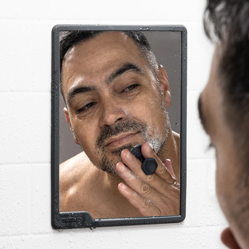 Charcoal shower mirror in use for shaving with fog-free reflective surface — Adventure Awaits
