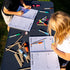 Young children drawing in the spiral bound kids travel journal 
