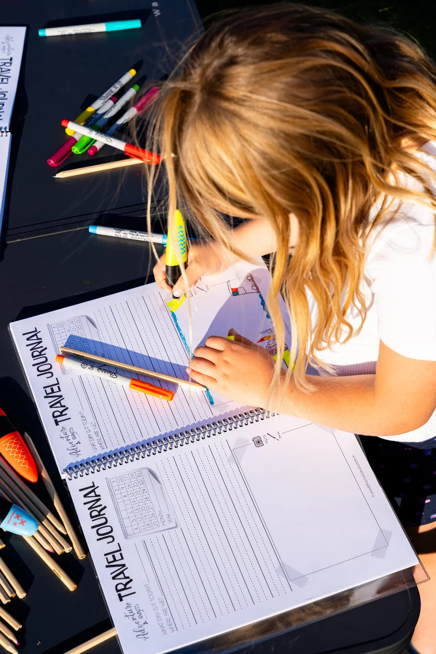 Pictures being drawn into the kids travel journal 
