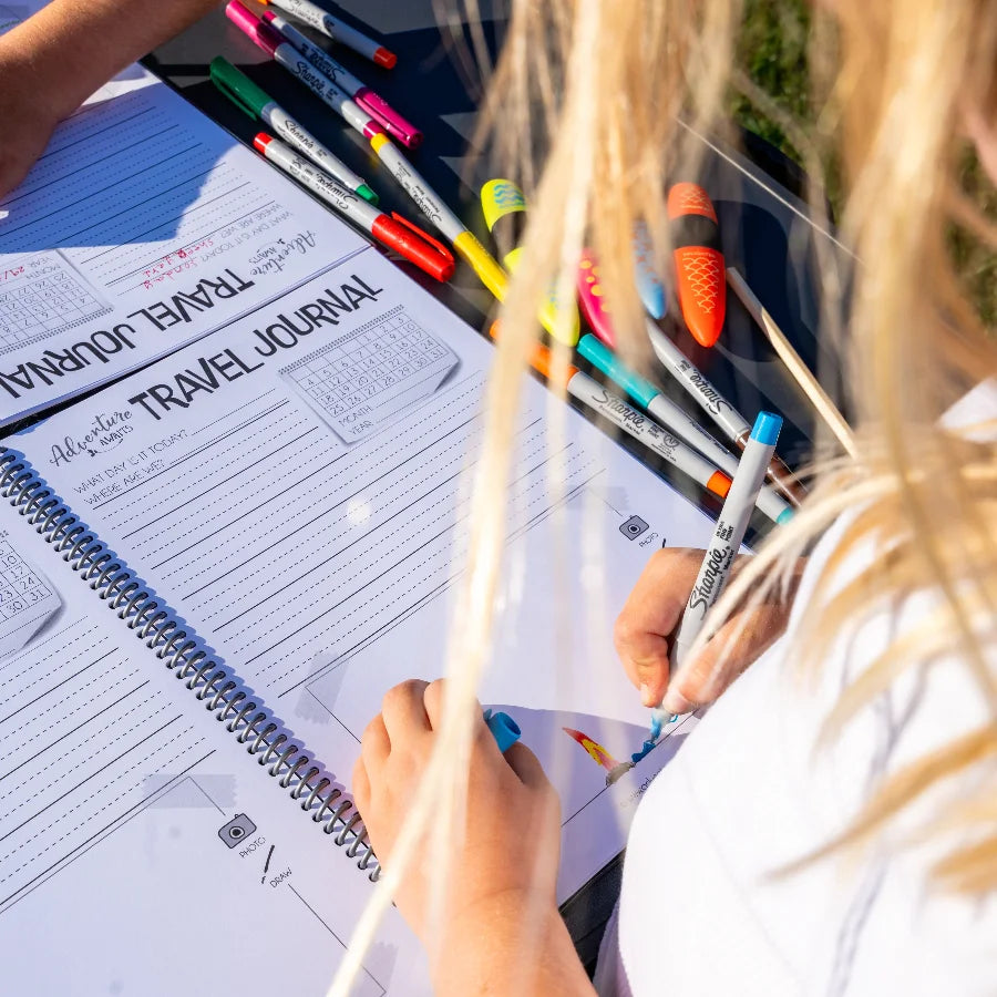 Drawing pictures in our kids travel journal 