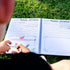 Opened Kids travel journal laying out on grass