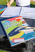 Kids travel journal spiral bound, laying on table with pencils 