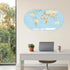 World map wall sticker above a white office desk with laptop, by a window framing Aussie gum trees — Adventure Awaits