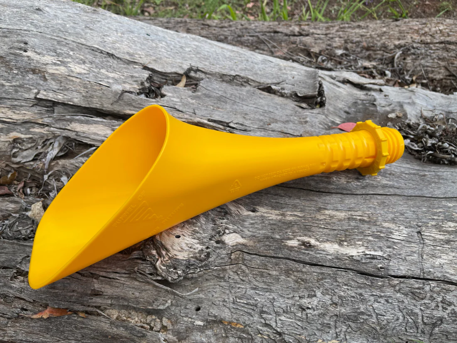 Yellow fuel funnel resting on weathered timber for car and caravan refuelling — Adventure Awaits