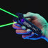 Close-up of the ZipString Luma handheld launcher in use, with glowing green strings shooting from the device against a dark background.