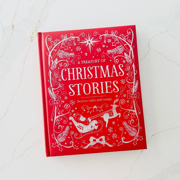 Red book titled 'A Treasury of Christmas Stories' on a white textured surface