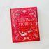 Red book titled 'A Treasury of Christmas Stories' on a white textured surface