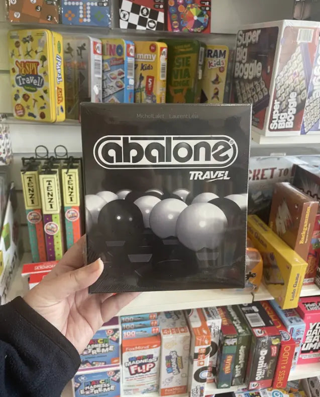 Abalone Travel strategy game box held in store — Adventure Awaits
