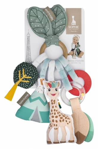 Sophie La Giraffe baby sensory toy set on a white background, featuring a green leaf-shaped rattle, a giraffe plush, a tree toy, and other colorful accessories attached to a printed backing card.