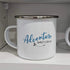 White mug with 'Adventure Awaits' text on a shelf