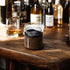 wood grain insulated whisky tumbler on bar table with spirits and glasses in background, modern drinkware for home bar or entertaining Adventure Awaits