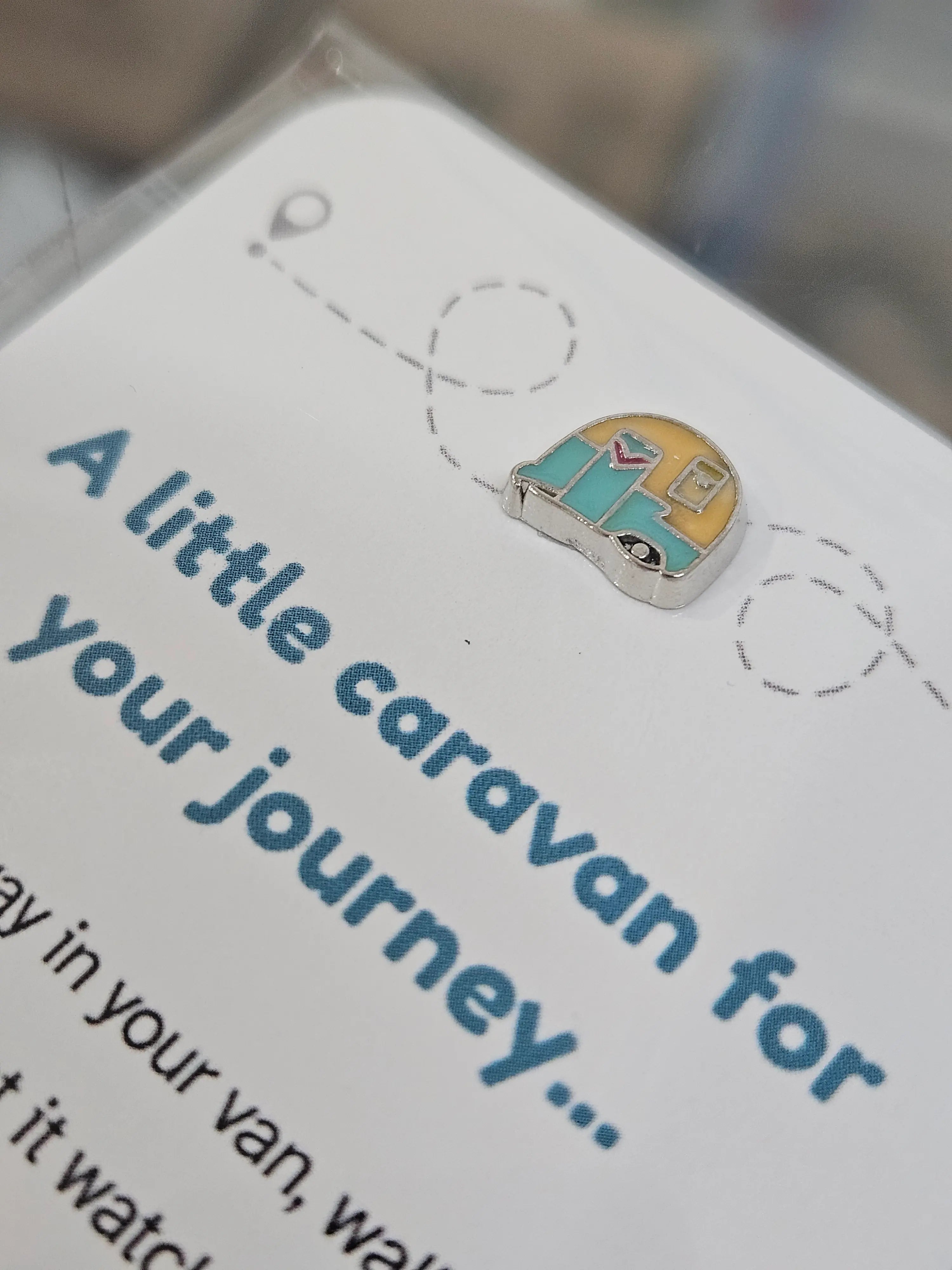 Close up of enamel caravan charm on the caravan keepsake card, teal and mustard tones — Adventure Awaits