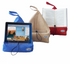 The Book Seat in blue, beige and red holding a tablet and open books hands-free — Adventure Awaits