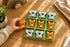 Child playing Koala Dream wooden tic tac toe game with koala and kangaroo pieces — Adventure Awaits