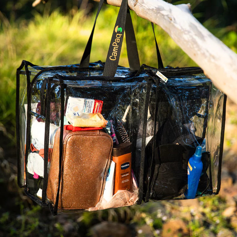 Campaq clear hanging storage bag packed with toiletries and camp gear at a campsite — Adventure Awaits