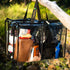 Campaq clear hanging storage bag packed with toiletries and camp gear at a campsite — Adventure Awaits
