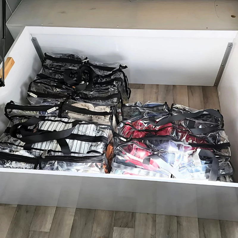 Clear Campaq storage bags packed under a caravan bed for easy travel organisation — Adventure Awaits