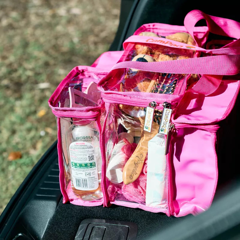 Pink Campaq clear toiletry storage bag packed with toiletries in a car boot — Adventure Awaits